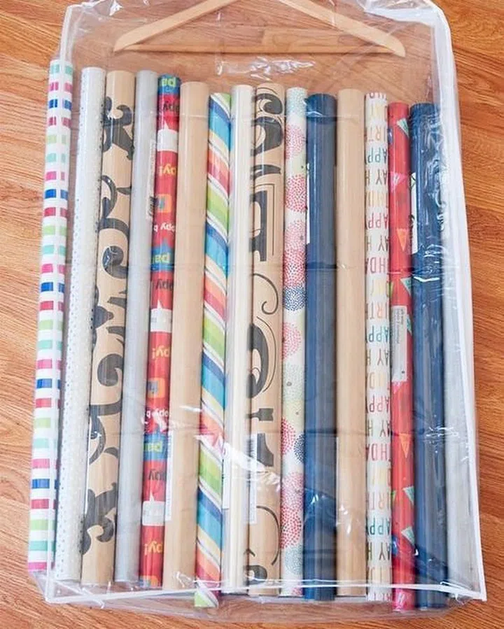 Tuck rolls of wrapping paper in a garment bag, so you can store them neatly out of sight.