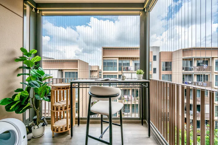 The enclosed balcony doubles as an outdoor workspace, coffee corner and one of the cats’ favourite lookout spots.