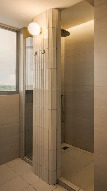 Glass doors in the master bathroom allows light flow into the bedroom in a 4-room HDB in Punggol.