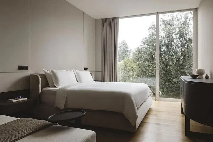 The walls of the master bedroom in this 8 Napier Road condominium are clad in a light-taupe-toned wallpaper for a quiet, calming effect. (Photo: Studio Periphery)