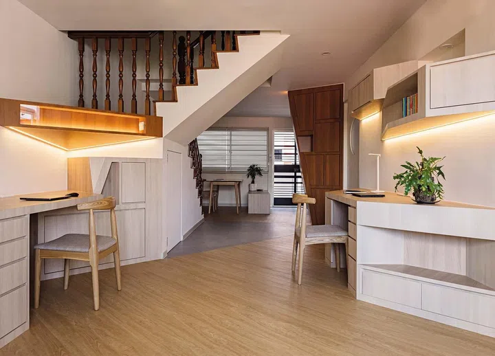An angled study table opposite the staircase acts as a funnel that draws you into the reading and study area.