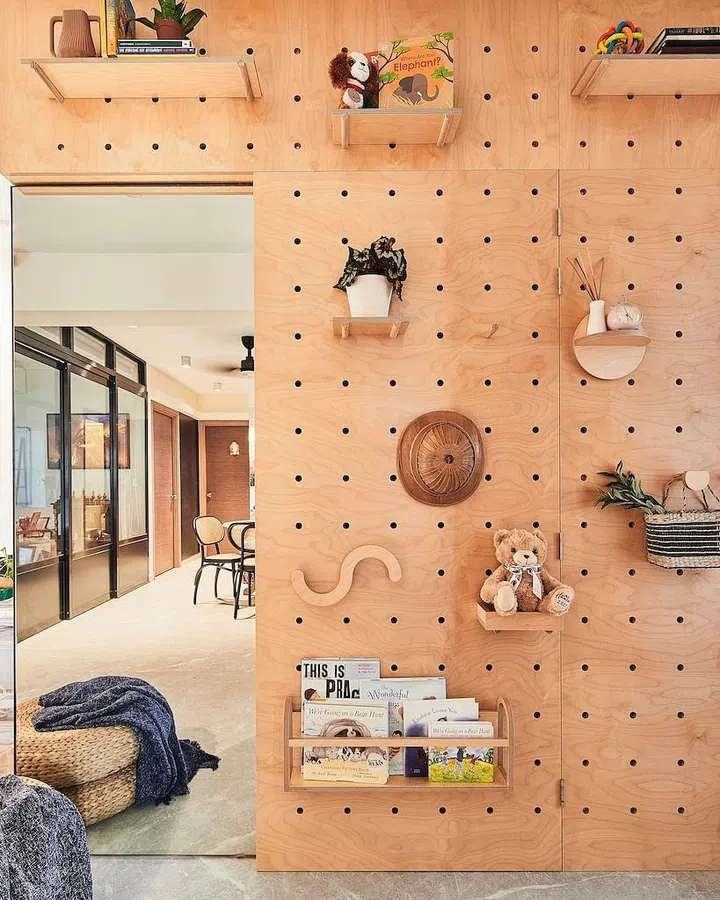 The pegboard wall allows the homeowners to rearrange their display space whenever they feel like it.