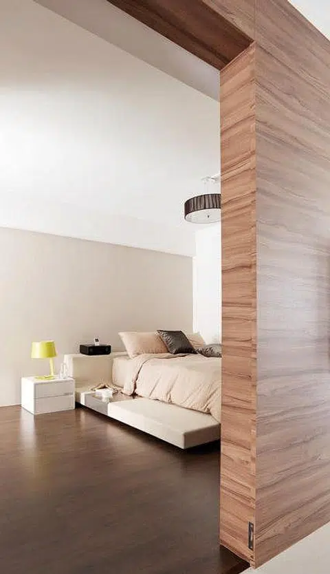 A table lamp from Boconcept brightens up the minimalist bedside table whereas the versatile bedframe from Furniture Club has head and side elements that double as shelves for bedside reading.