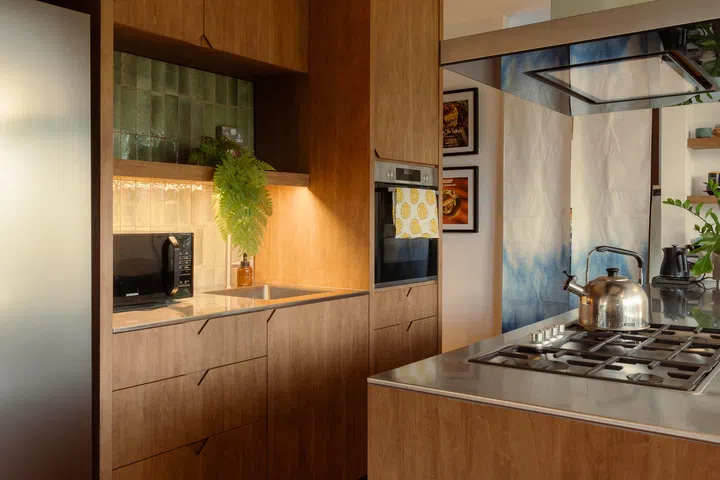 Design details extend the acute motif into the kitchen, most notably in the angled drawer pulls.