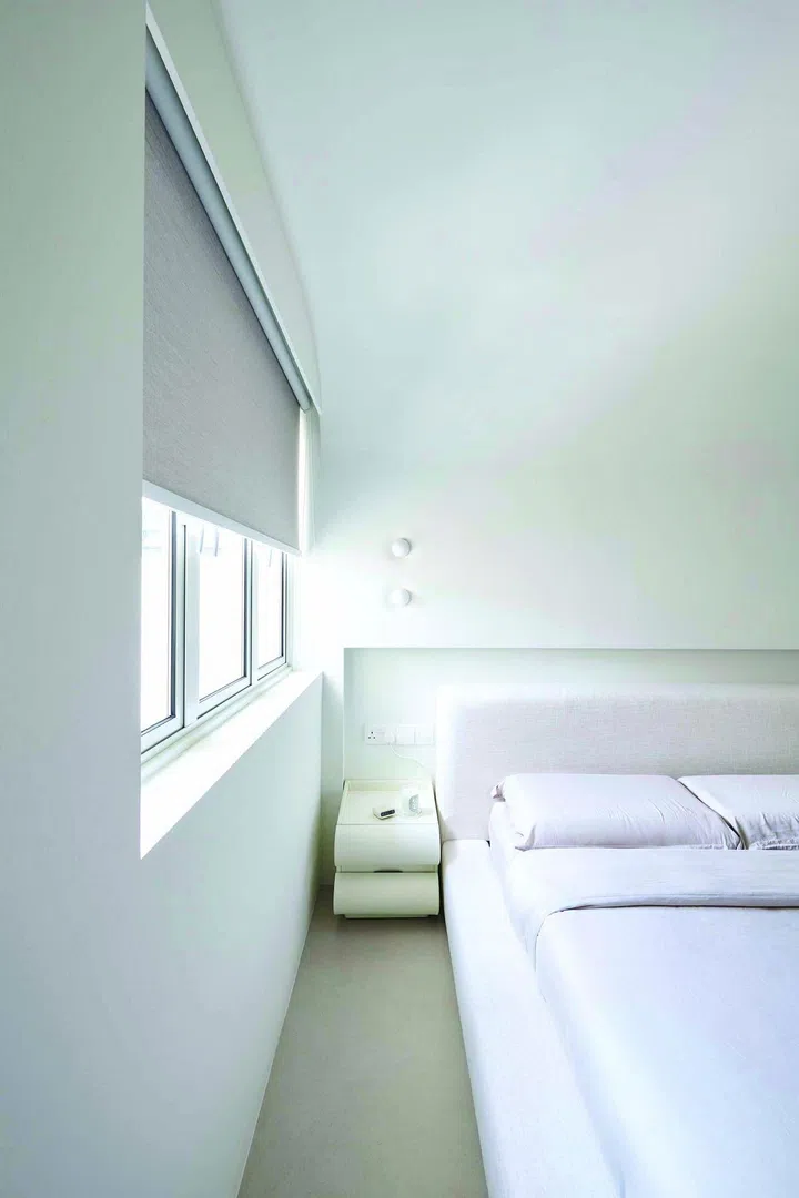 Her white and grey minimalist bedroom provides a sense of tranquility and calm.