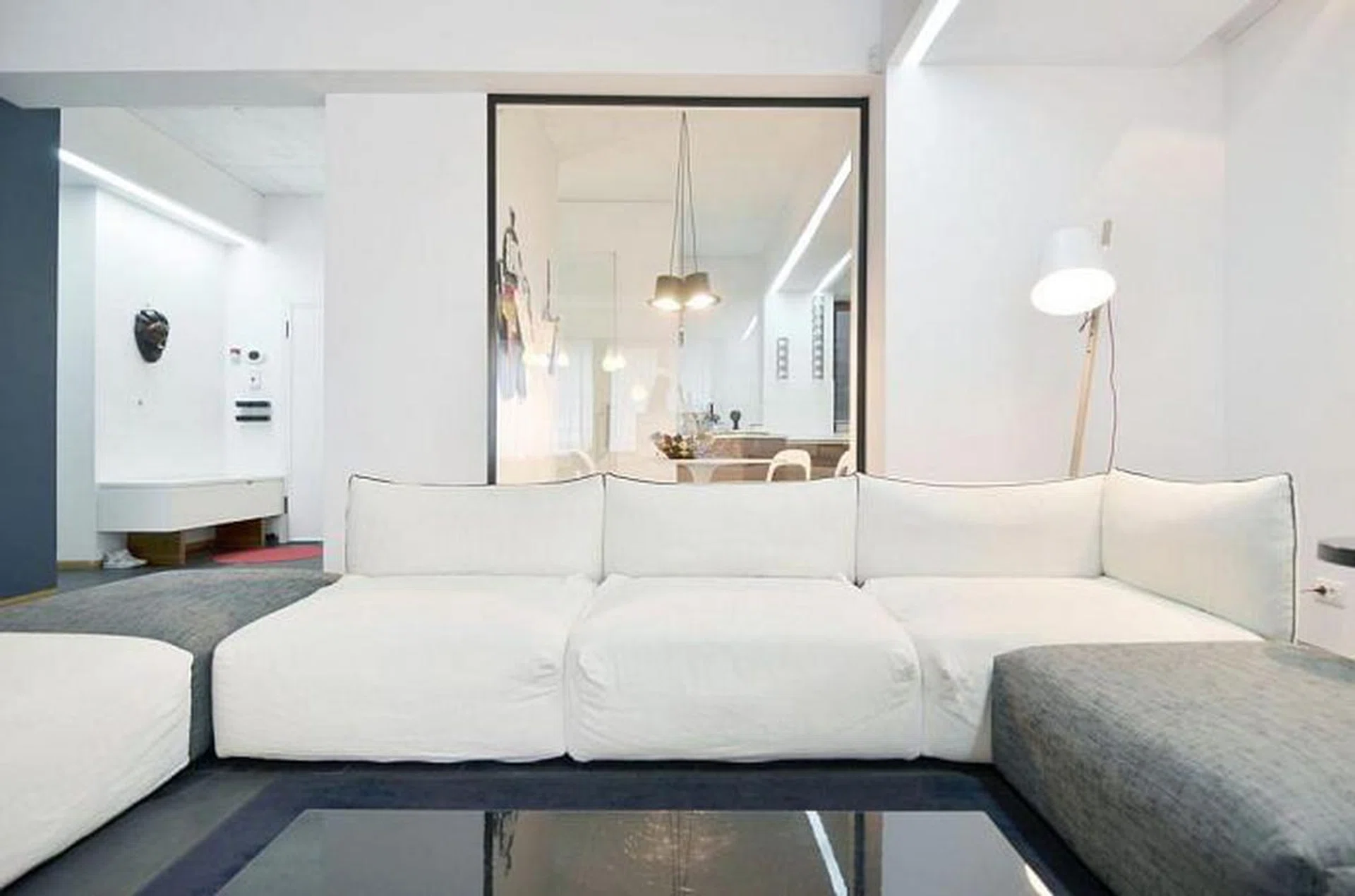 The glass wall offers a look all the way into the kitchen, adding a sense of depth to the home. 