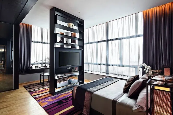 To help zone the various spaces in a bedroom, a full-height TV console is installed in between the sleeping area and work area.