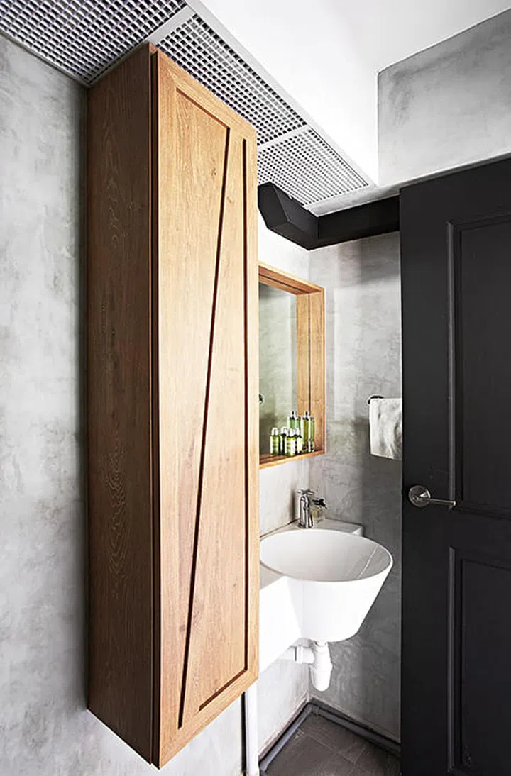 A crate cabinet by the entrance to the common bathroom provides extra space for toiletries.