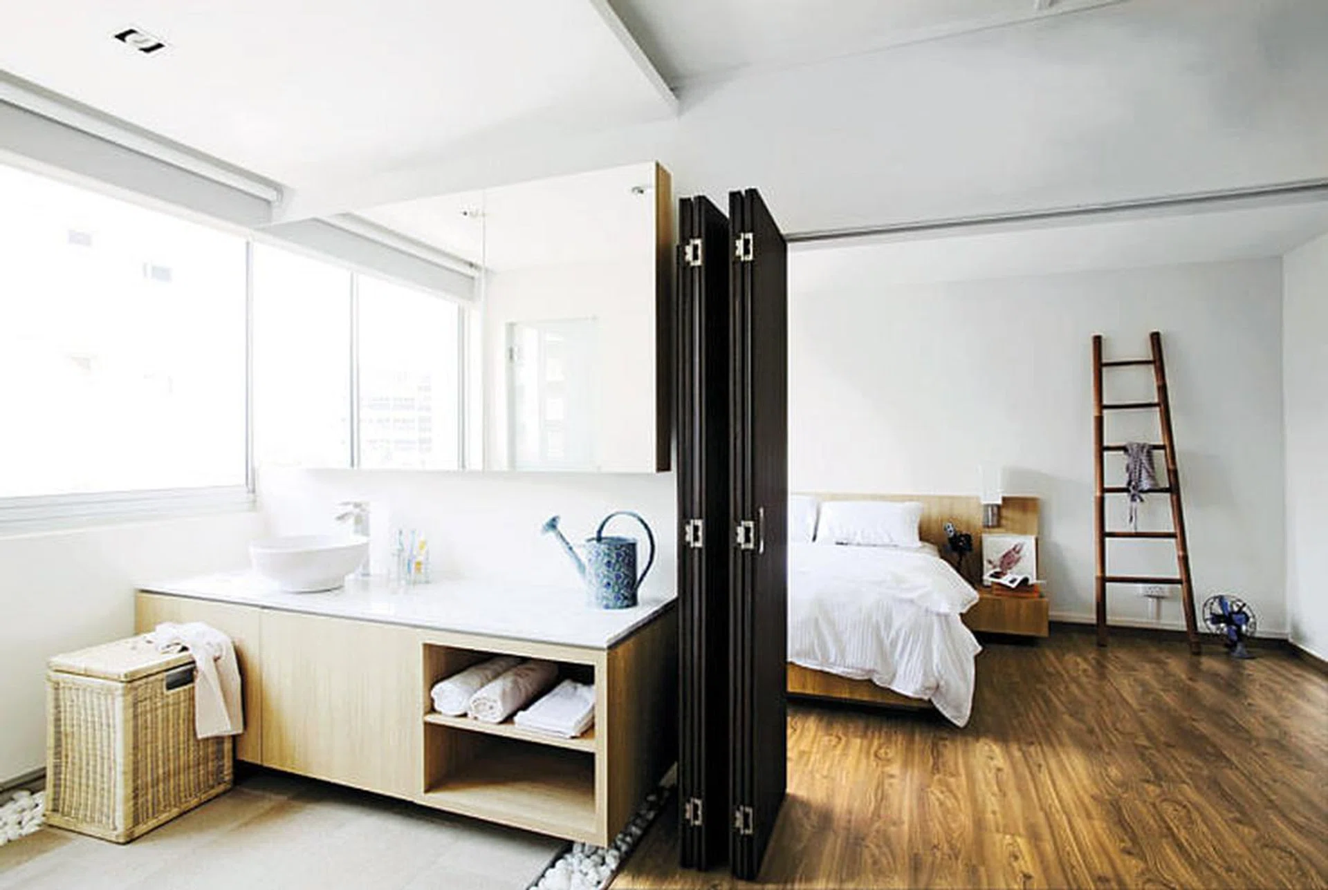 Combining the master bedroom with another room allowed for a large vanity area to be created outside the bathroom. Bi-fold doors separate the two areas. Watering can and framed bird print from Egg3. Interior design by Box ID Studio