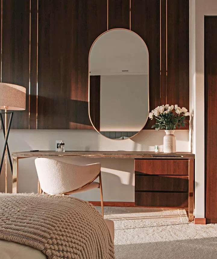 Furnishings with slim lines and curved shapes bring visual interest to the master bedroom.