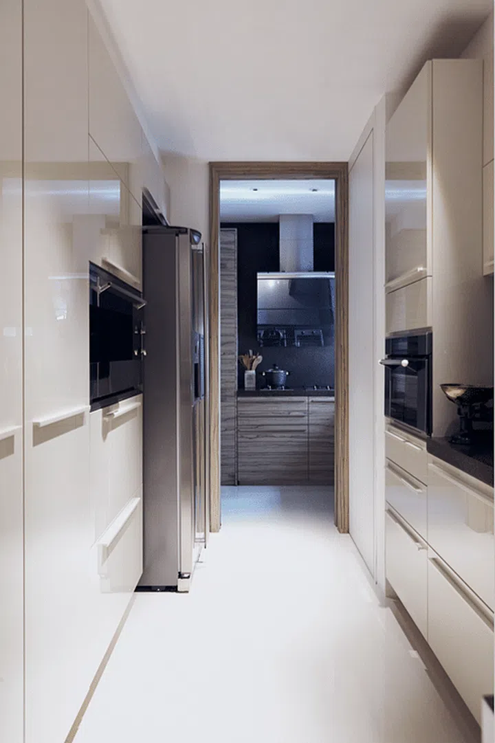 The kitchen has a sleek modern design, and is built with plenty of hidden storage space to keep it looking neat and clutter-free.