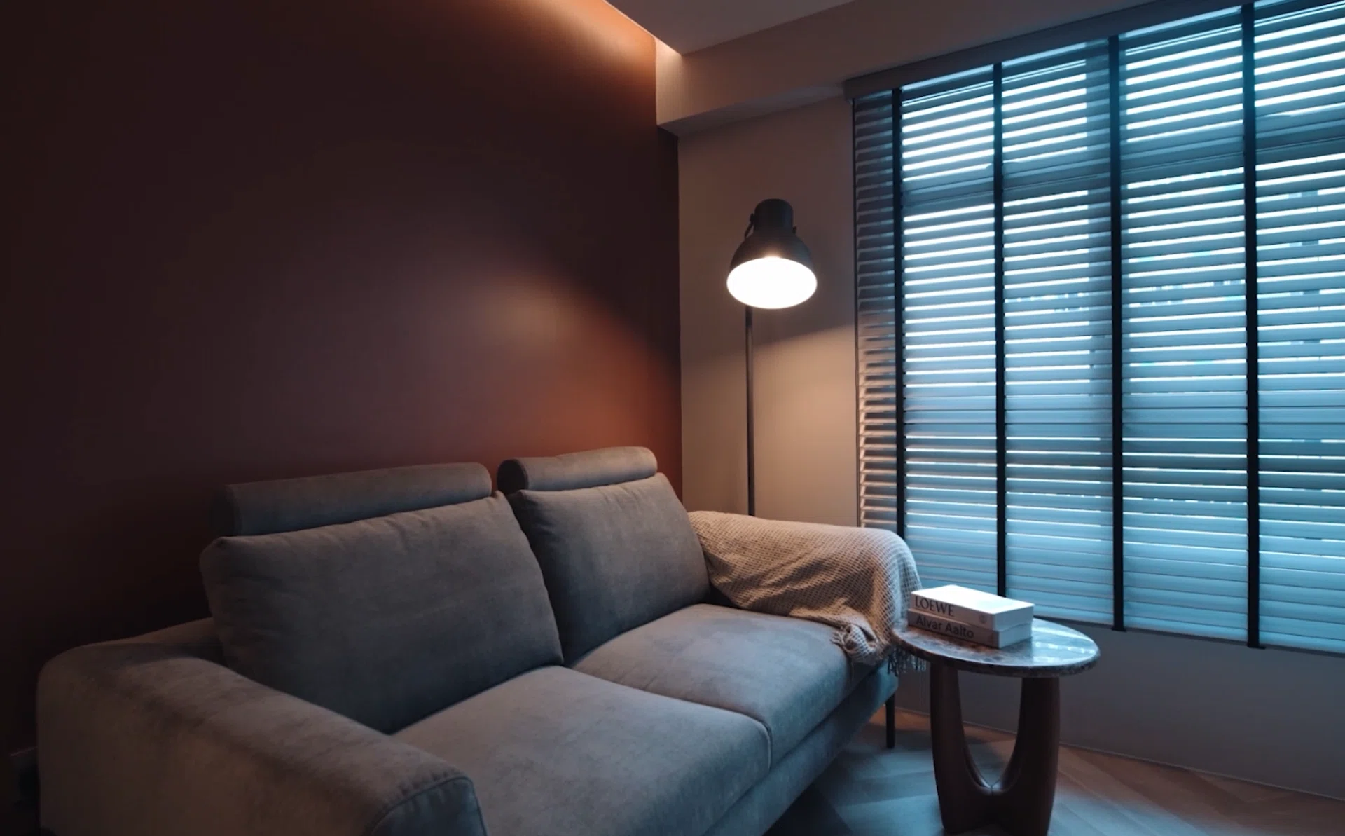 Warm lighting and earthy finishes create a hotel-inspired look in Sebastian’s compact 2-room HDB flat.