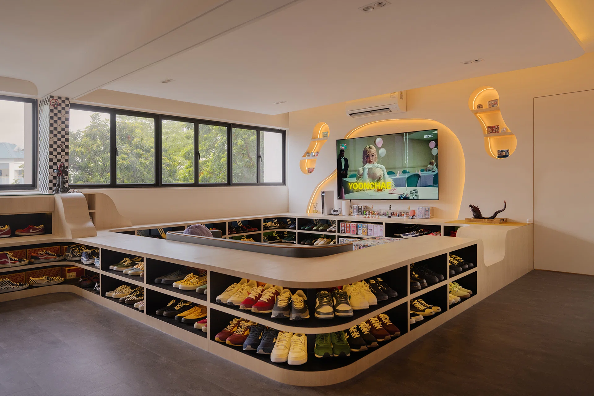 The conversation pit integrates seating with low display cubbies for Jumadi’s impressive sneaker collection.