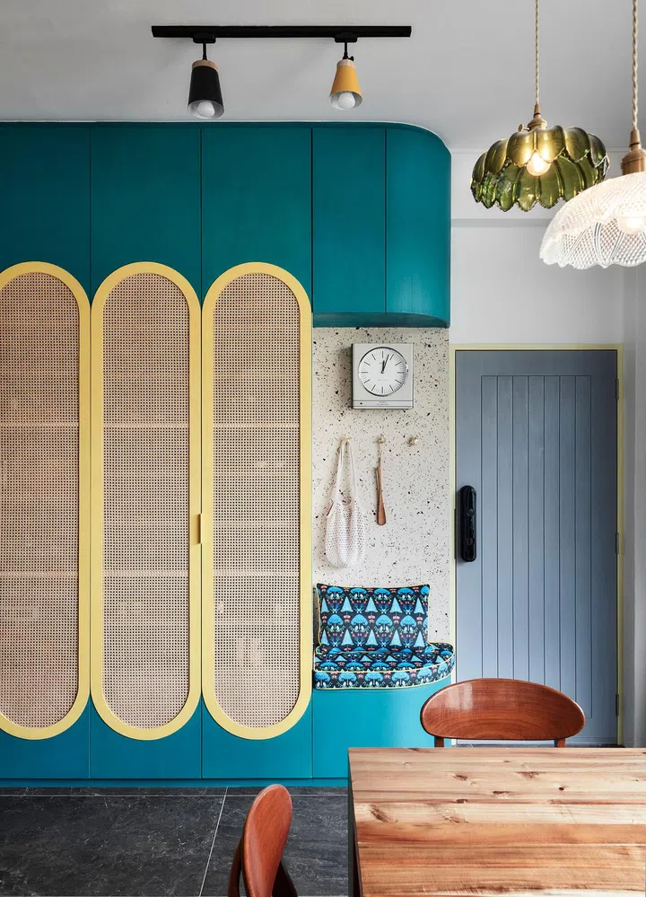 Closeup of the bright colours, shapes, and patterns in the entryway shoe cabinet in this 2-bedroom walk-up apartment along East Coast Road.