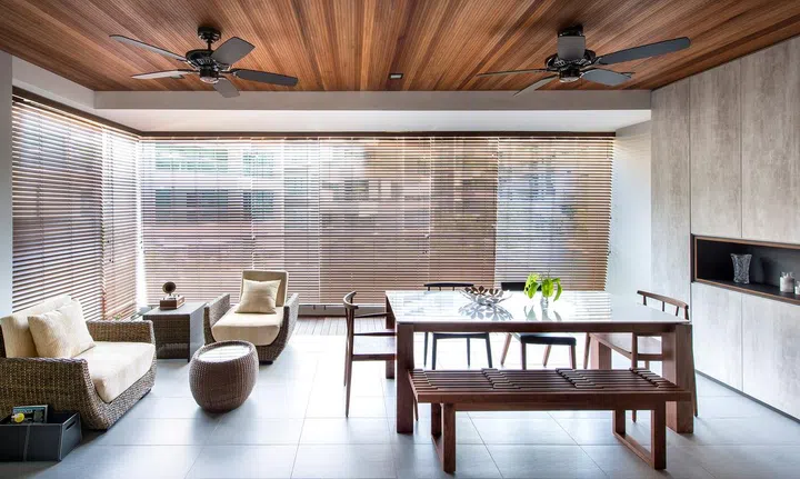 The balcony is absorbed as part of the living area with slim wooden strip ceiling as the main focus point. Dining table and chairs are bought from Air Furniture. The Beverly condominium in Singapore.