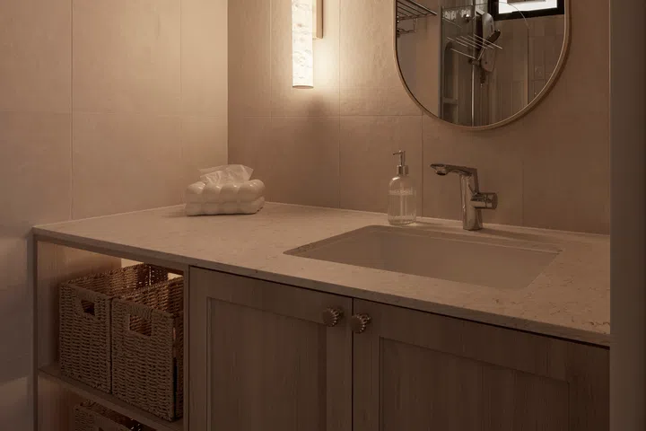 Warm lighting transforms the same vanity into a softer, more intimate space after dark.