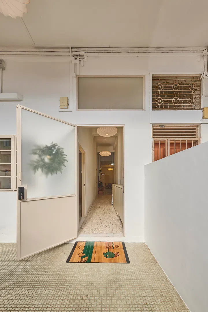 Light draws the eye towards the entrance, where the corridor opens out to the front patio.
