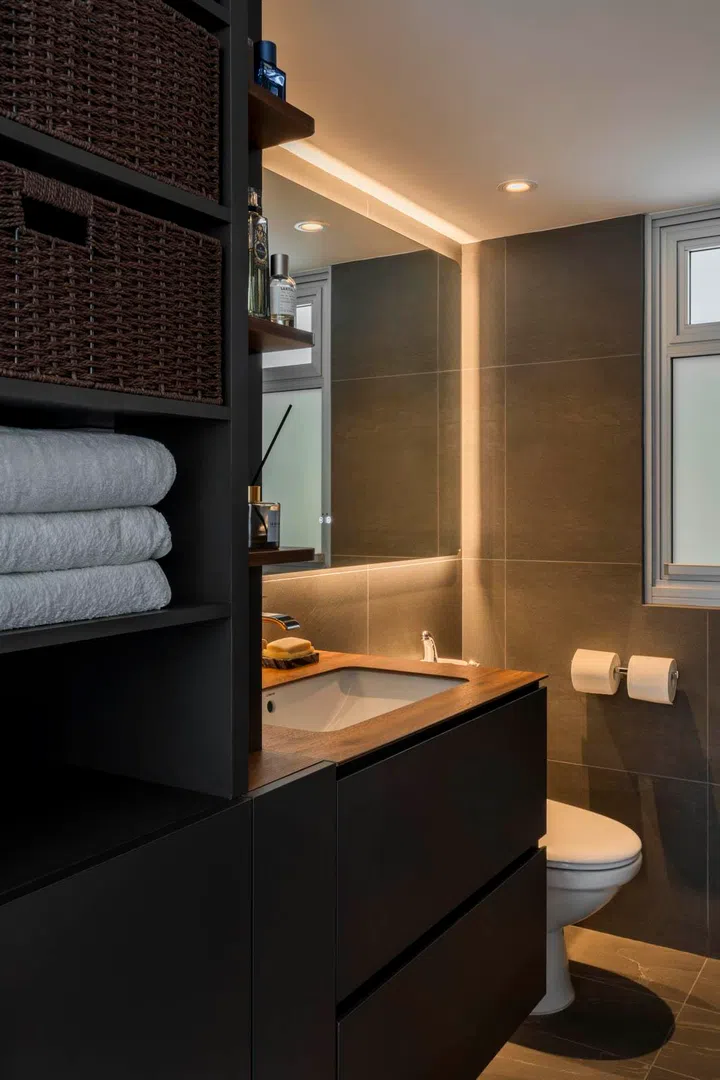The master bathroom is designed with clean lines and clever concealment, balancing practicality with a minimalist calm.