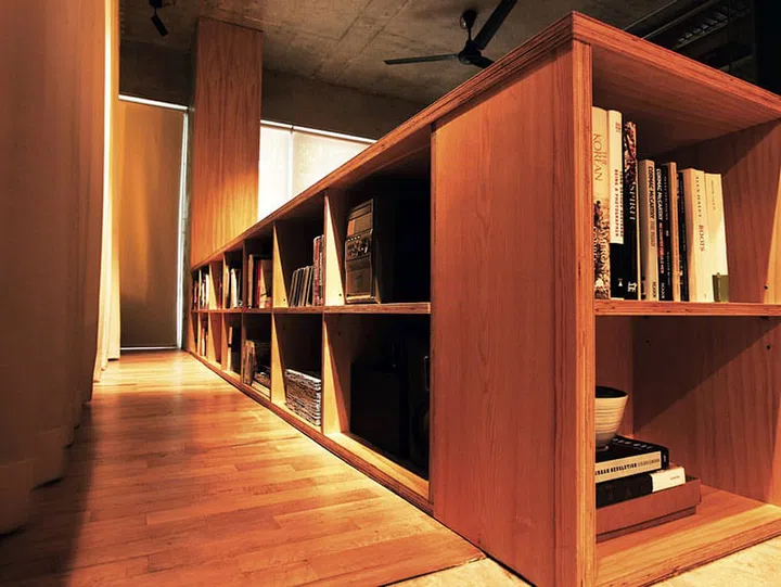 Exposed shelving lines the outside of the sofa frame.