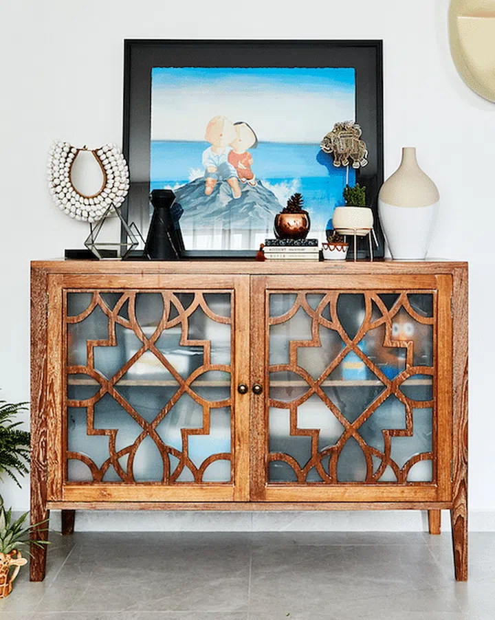 Chinese contemporary artist Wu Qiong's artwork on display on a wooden sideboard in Singaporean actor Jeremy Chan's house.