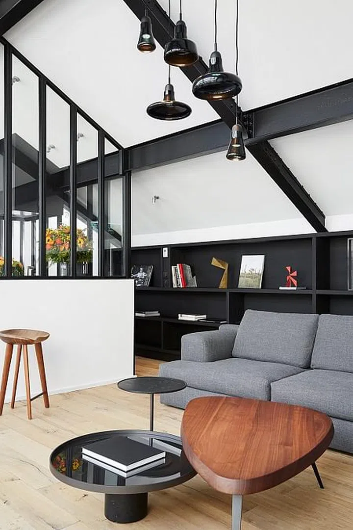 Wood furniture adds a softness to a monochromatic theme.