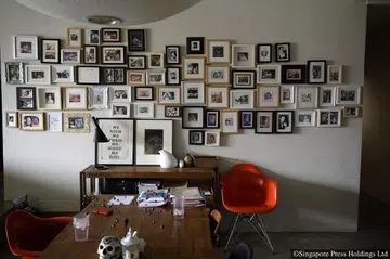 A wall of framed photographs in Ling Wu’s home along Toh Tuck Road.