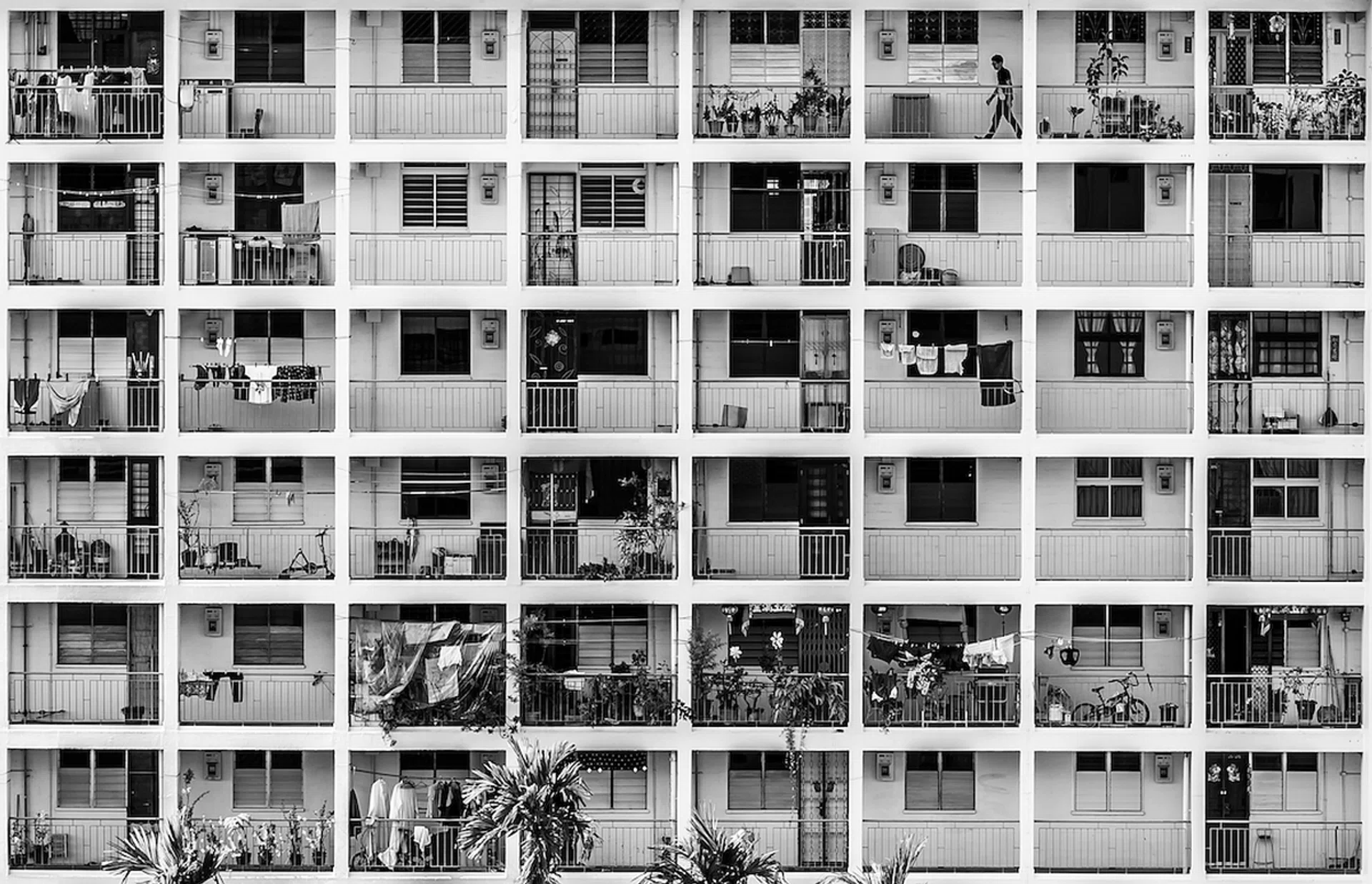 Black and white frontal view of an old HDB building with shoebox units in Singapore.