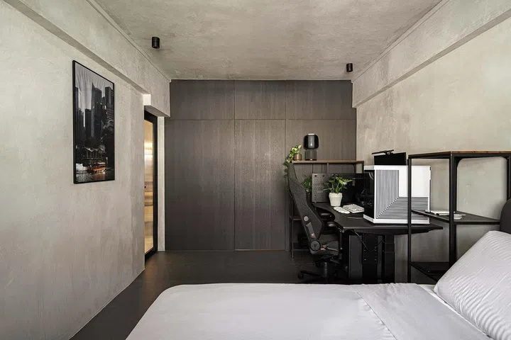 Cement screed walls run throughout the master bedroom in a 3-room HDB flat in Ang Mo Kio.