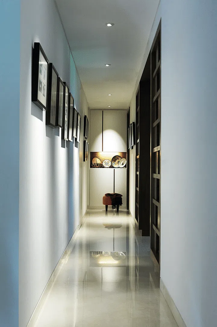 Besides using travel souvenirs for decoration, the homeowner also displays family photos along the corridor walls leading to the bedrooms.