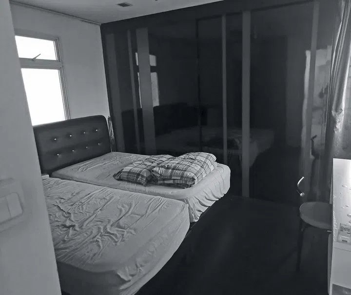 Two beds squeezed together in front of a wardrobe.