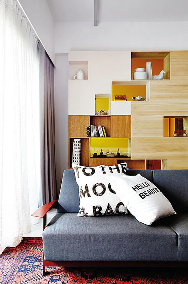 The Moroso Silver Lake sofa by Patricia Urquiola has a bright red frame and grey upholstery, adding colour diversity to the living area.