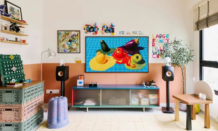 The living room in full view, showcasing eclectic pieces and the whimsical purple Canele stool.