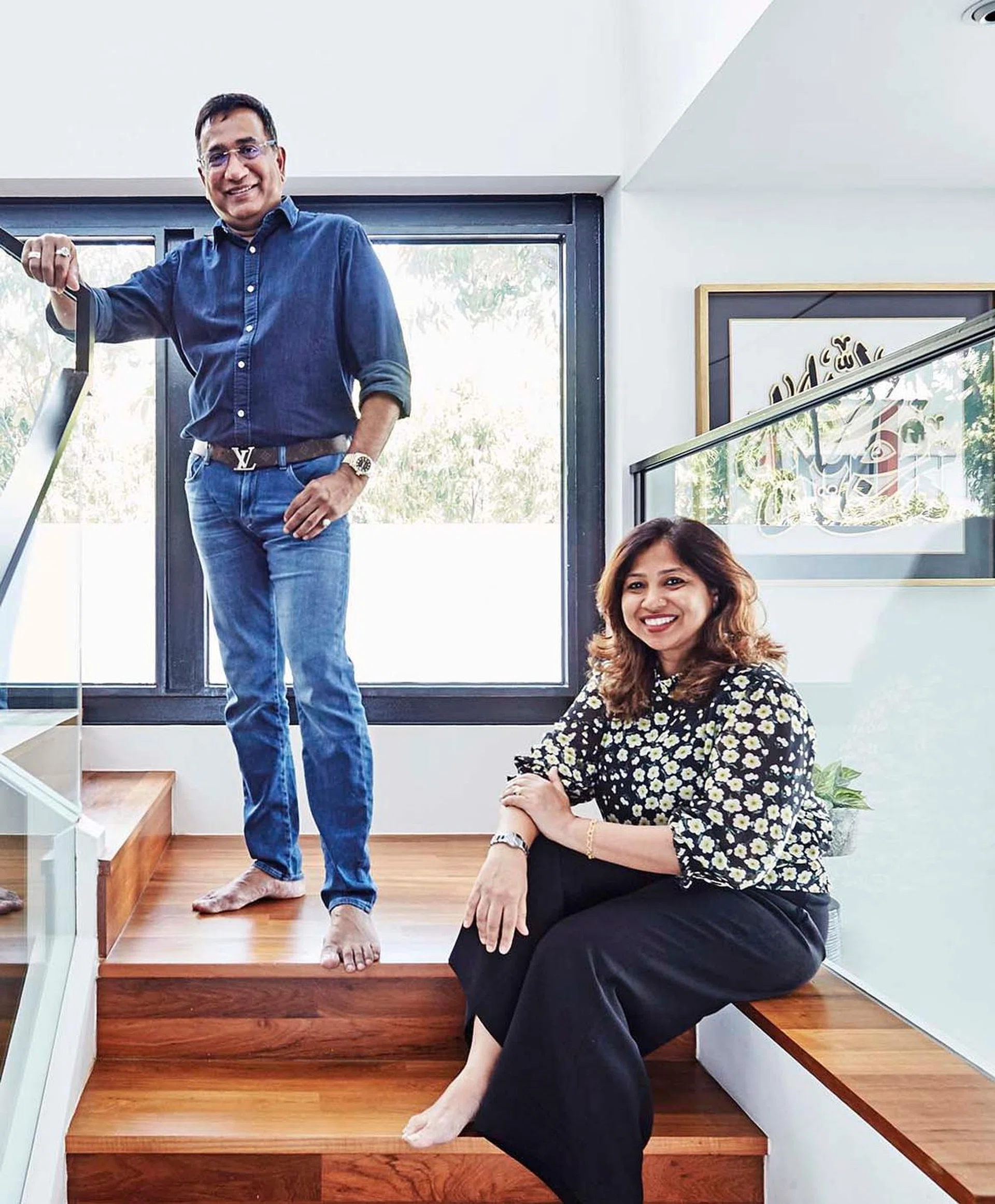 The Kareems, a couple in their 50s, photographed in 2021 at the stairwell landing in their 4-storey terrace house in Telok Kurau. Interior design by Hans Chua from Erstudio.
