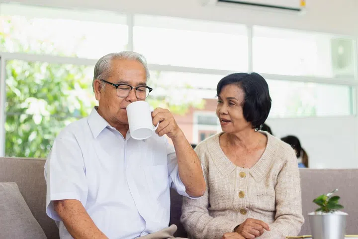 Nursing Home Care concept. elderly couple asian woman are sitting together happily.