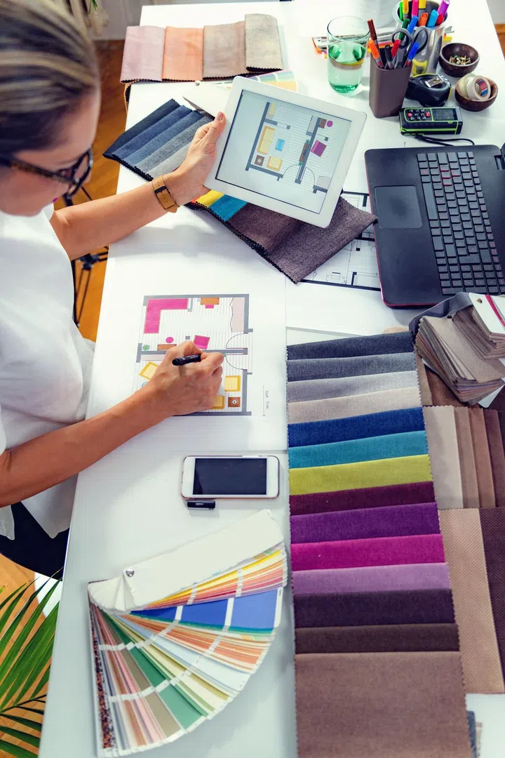 Interior designer, decorator, choosing material samples in studio