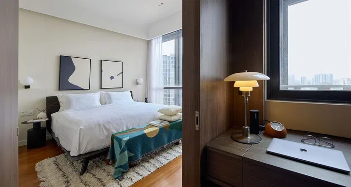 Master bedroom sliding door opens up to a built-in study desk by the walk-in wardrobe in this 840 sq ft 2-bedroom condominium at Hillview Rise.