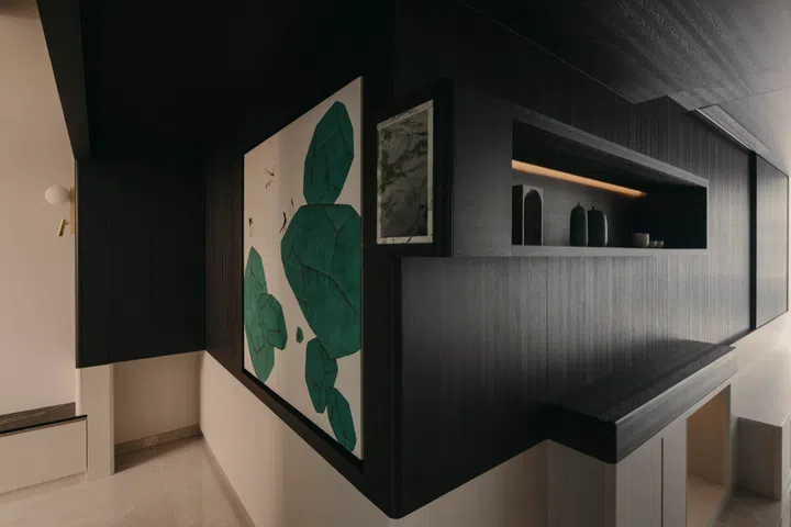 The artworks frame the corridor as a threshold rather than a passageway, setting the emotional tone before the space opens into the living and dining area of a 3-bedroom (1,098 sq ft) condo in Penrose.