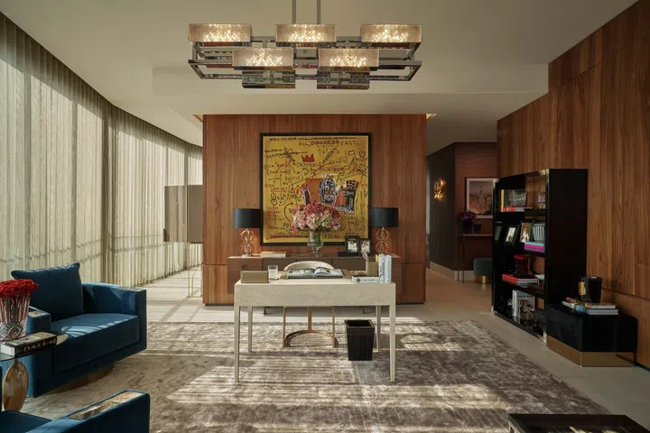 Velvety-soft furnishings, touches of gold and strategically-placed lighting create an aura of luxury in the Office Salon. set off beautifully by the large artwork in the middle.