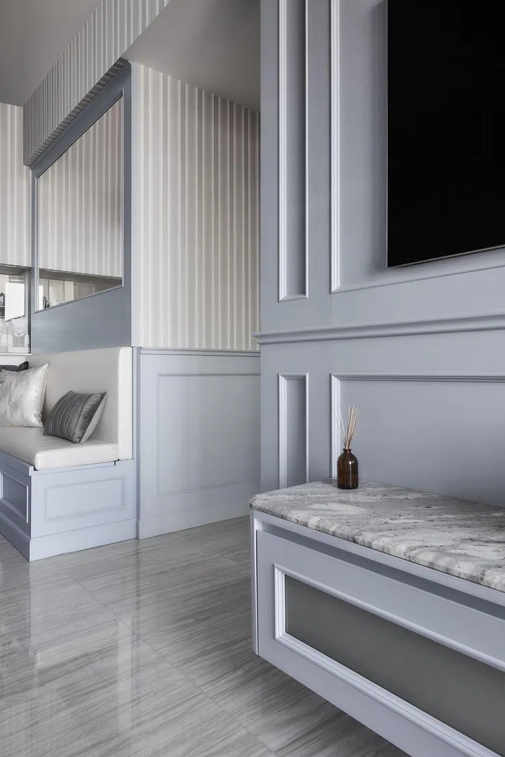 Half-height wainscot walls in the dining room of a flight steward's 2-bedroom with study condominium along Sims Drive designed by The Cottage Crafts.