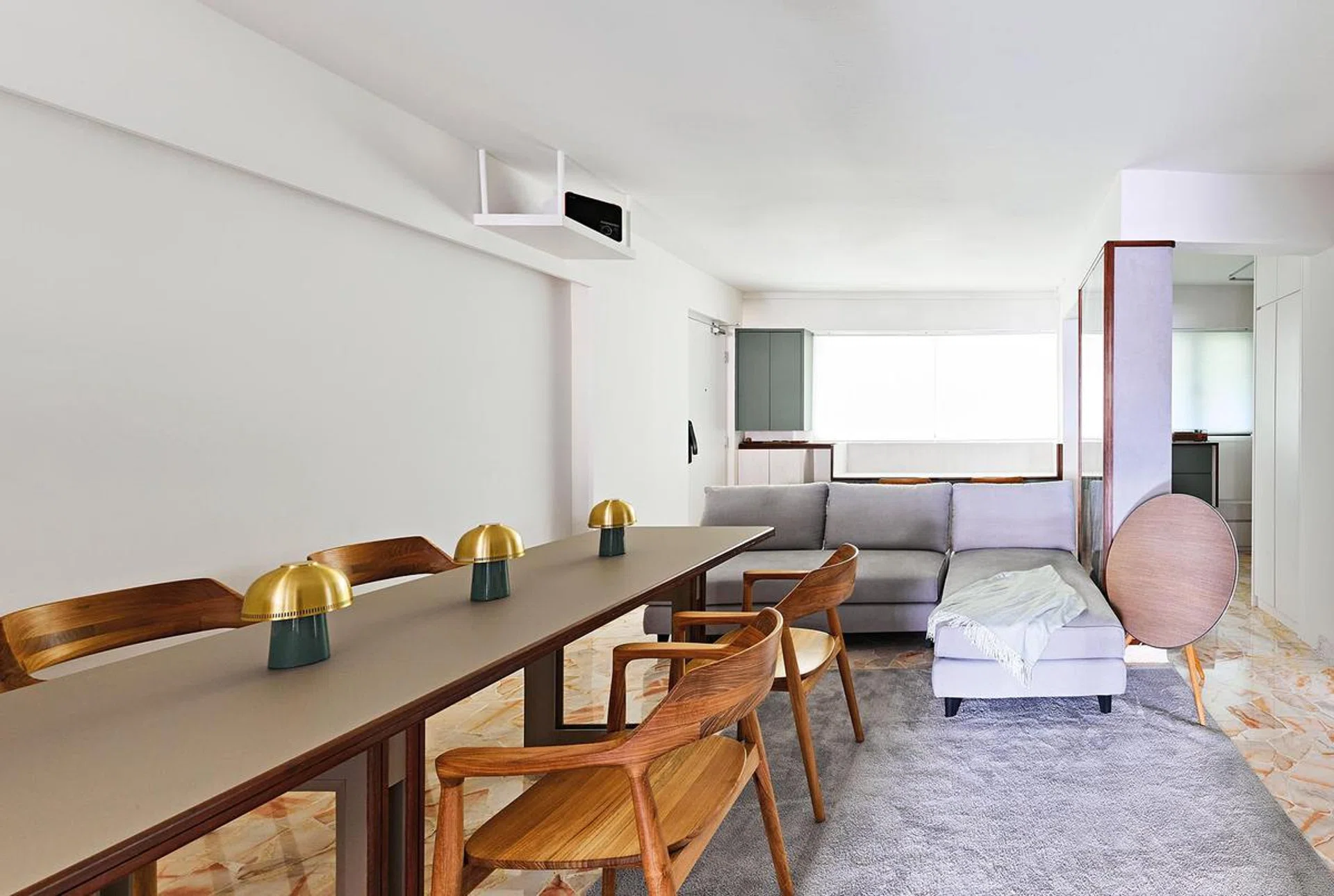 A modular sofa and custom- designed dining table on lockable wheels
