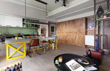 The foyer of this apartment is lined with barn-style doors which conceal pockets of storage. Interior design by HAO Design