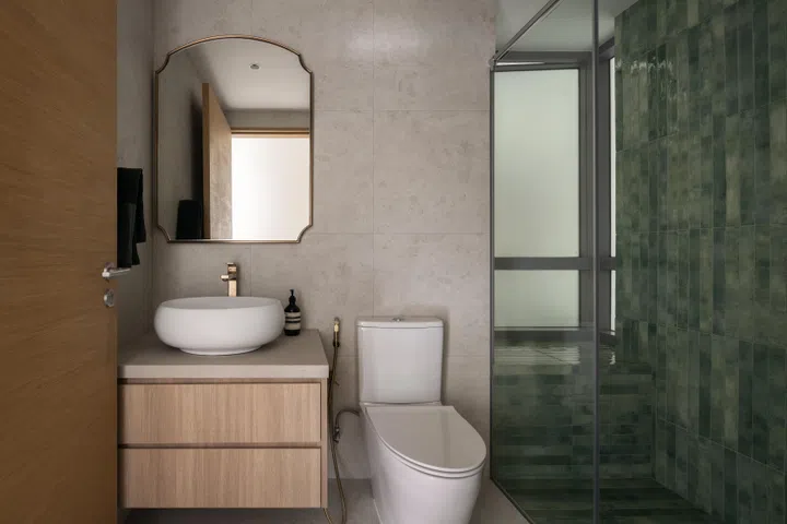 The common bathroom has a custom vanity, toilet and shower. 