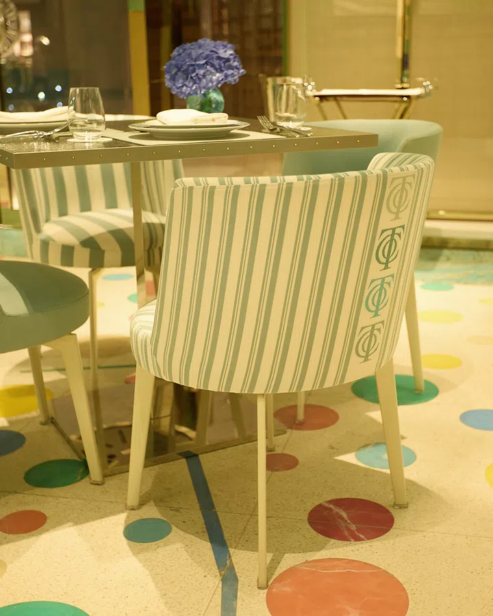 Large-format distressed polka dotted terrazzo floor tiles.