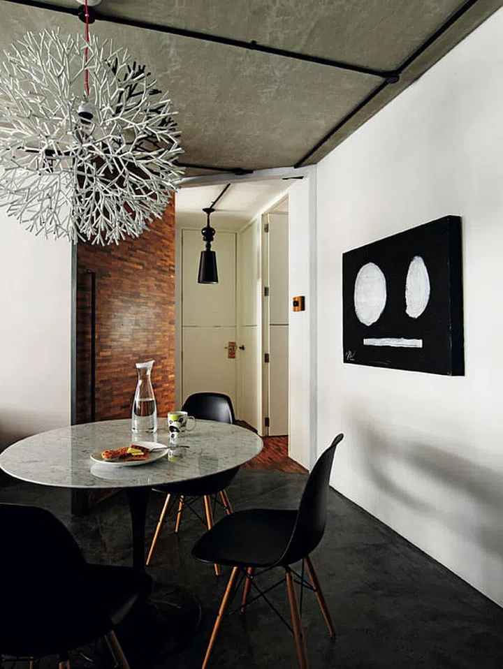 The wide, slanted door sections off the bedroom from the rest of the home, creating a public-private divide when the door is closed.