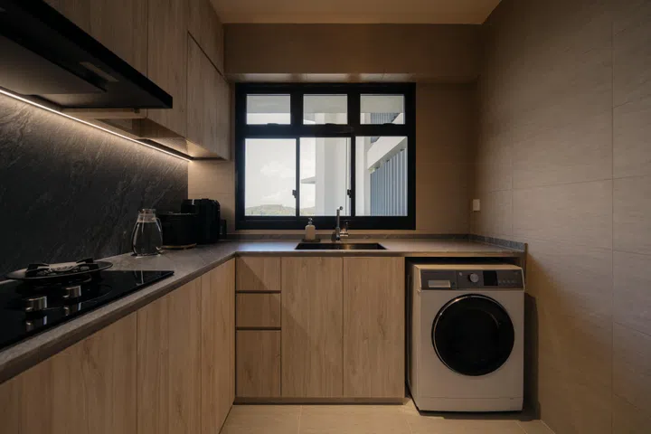 The L-shaped layout maximises workspace and storage, with a window that frames sea views beyond.