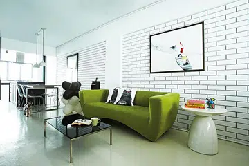 A pop of green in the living room injects life into the monochrome scheme.
