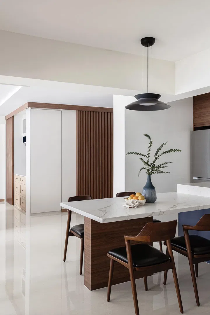 The design team transformed the area with the household shelter into a practical corner with shoe storage, a bar area, and a wine fridge.