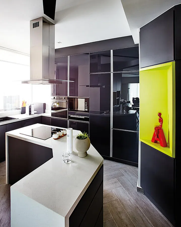 The kitchen walls were demolished and replaced by an island counter so homeowner, Yvonne, can enjoy the view when she’s cooking.