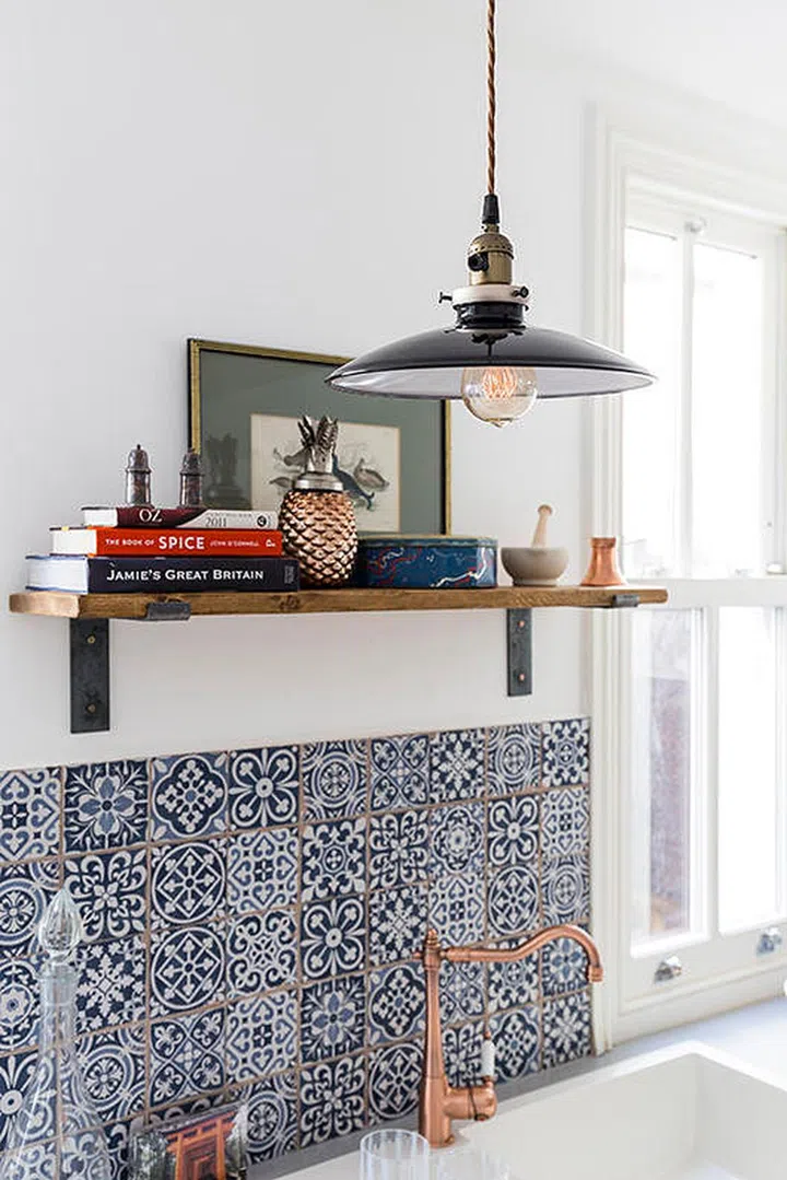 Single open shelf above a kitchen sink. Stack a bunch of your favourite cookbooks on an open shelf. Interior Design by Anouska Tamony.