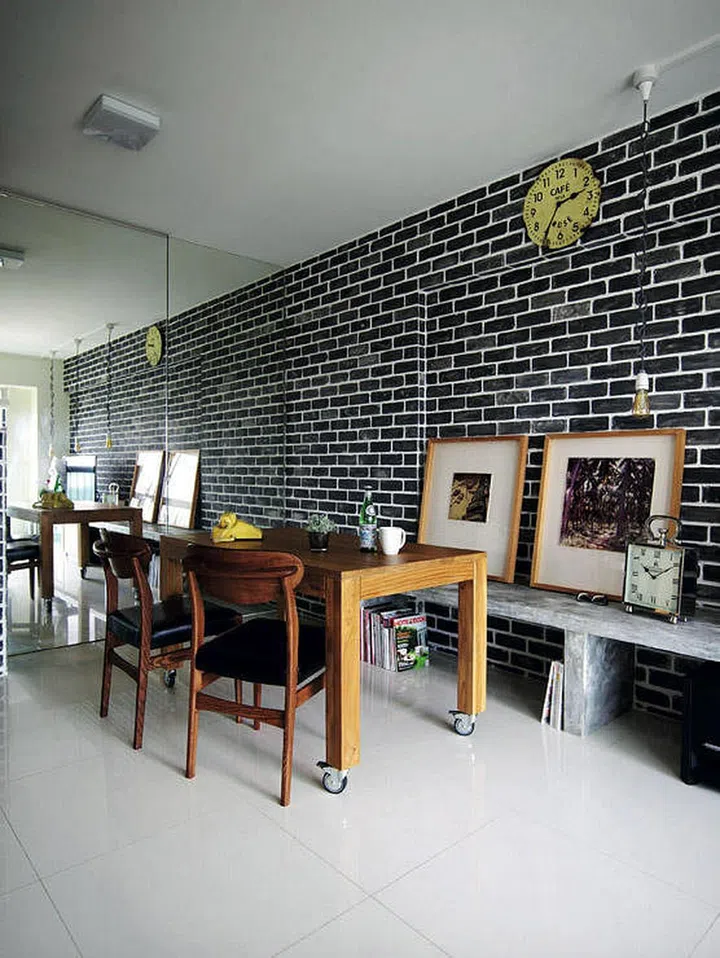 The mirror that clads the entire wall also hides the entrance to the bomb shelter.